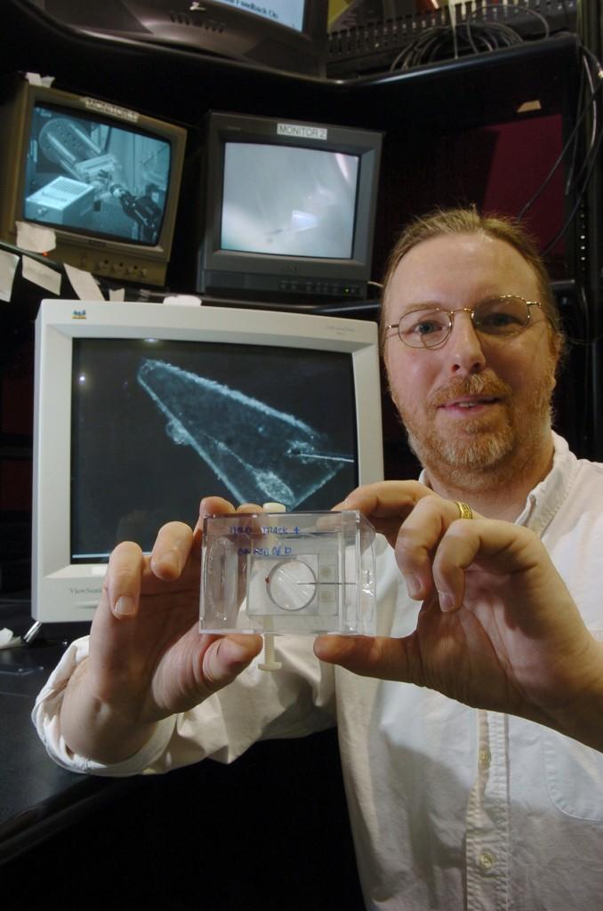 Matthew Newville inspects a sample from a piece of comet. Newville has been involved in many different research studies with other scientists from around the world.