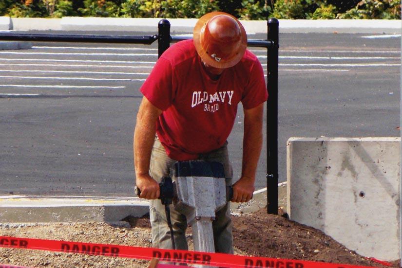 A construction worker uses a jack-hammer while finishing the senior parking lot construction. The lot is to be open on Tuesday to coincide with the first day of school for seniors according to Lou Bailey, prinicpal. 