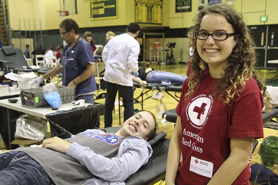 Isaac+Wilkinson%2C+senior%2C+and+Anna-Maria+Hartner%2C+junior+and+president+of+WLHS%E2%80%99s+Red+Cross+Club%2C+converse+during+the+blood+drive.+The+drive+generated+96+viable+units+of+blood+that+may+save+up+to+284+lives.+