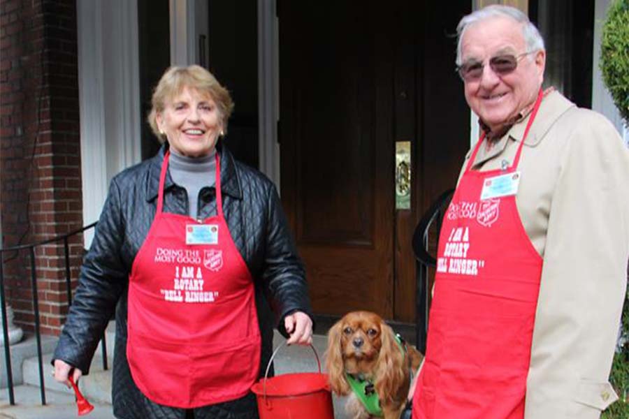 Lois and Ward Cook ring bells in front of Arlington Club to solicit donations for the Salvation Army. They are accompanied by their dog Malka, whose name is Hebrew for “queen.” The married couple volunteer as Salvation Army rotary ringers every Friday for an hour-and-a-half.