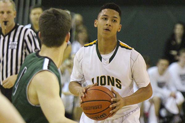 Jaydon Grant, junior, looks to pass the ball last Friday against Tigard. Grant helped the Lions to a 55-53 victory by scoring five points.