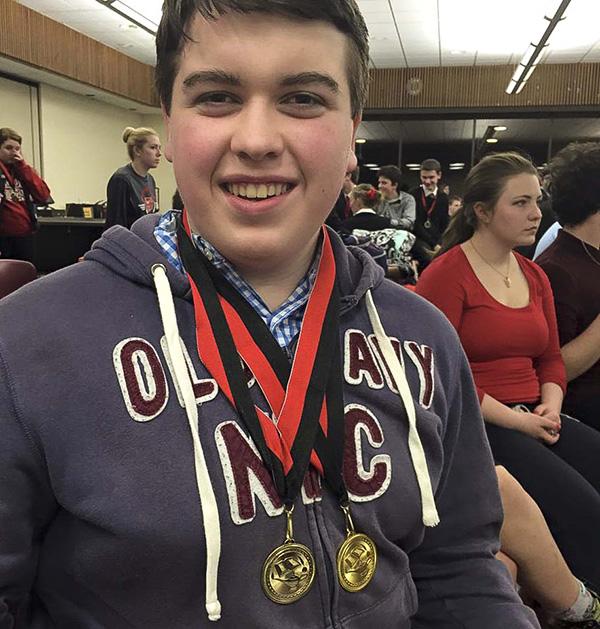 Joe+Erickson%2C+junior%2C+displays+his+first+and+second+place+medals.+He+has+qualified+to+compete+in+the+state+tournament.
