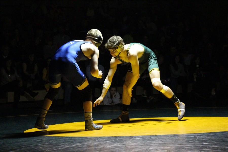 Kane Snapp, junior, looks for a move against his opponent in the Newberg Match earlier this season.