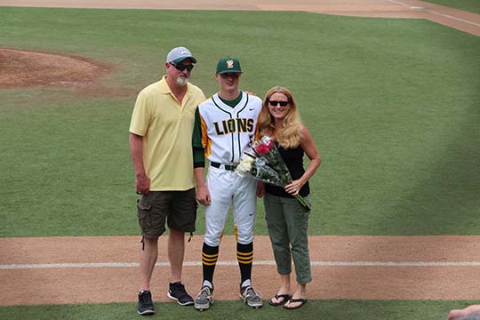 Karsen Lindell, senior, is honored with his parents on senior night held on, May 18.  Lindell threw a one hit game for the Lions against Central Catholic in the OSAA State Quarterfinals, helping them to earn a 2-1 win over the Rams. Next up is the semifinals against McMinnville, Tuesday 5 p.m. at WLHS. 