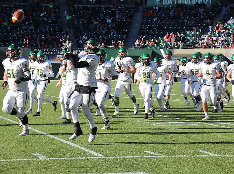 Running back Elijah Molden, junior, leads the Lions onto the field before the matchup began against second ranked Sherwood in the OSAA Semifinal game. West Linn defeated Sherwood 51-7 last Saturday at Providence Park. 
