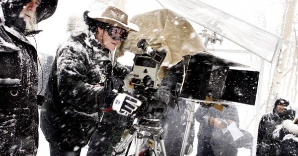 Quentin Tarantino (right) and Director of Photography Robert Richardson (left) are seen framing up a shot in the cold. The cameras and lenses used in the production had not been used for almost fifty years and had to be restored back to working order to be used in the film. The 65mm cameras allow for the film to be seen in special 70mm roadshow showings in 100 venues across 44 different cities.
