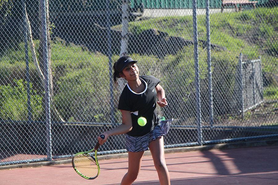 Going+for+the+hit%2C+Sophomore+Gretel+Rajamoney+plays+singles+against+Grant.+The+team+left+with+a+victory+of+7-1.+