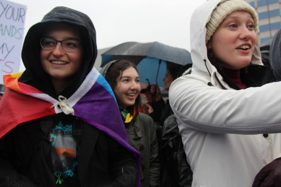 Wrapped in an LGBT pride flag, Maxi Muessig (left), senior and president of the GSA,marches throughout Portland for what she believes in, accompanied by Sydney Steinberg (middle), sophomore, and Deanna Plunkett (right), senior. 