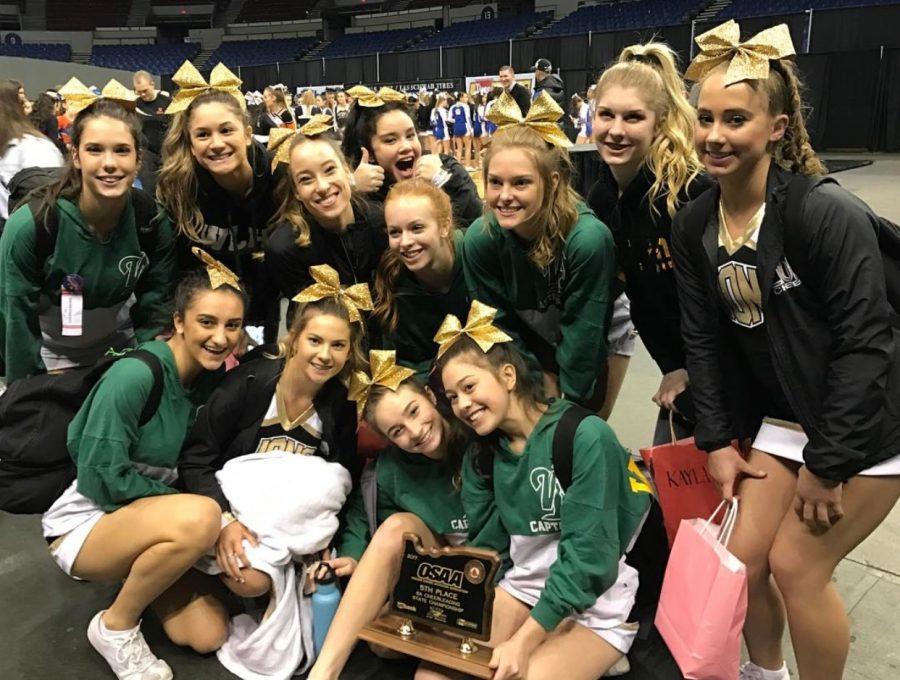 Varsity sports a fifth place trophy after competing at the State Cheer Competition.