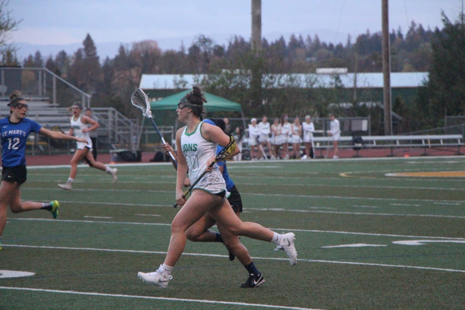 En+route+to+her+second+goal+of+the+night%2C+Ragen+Finklea%2C+sophomore%2C+leads+the+team+to+victory+on+Tuesday+against+St.+Mary%E2%80%99s+high+school.+Finklea+plays+club+lacrosse+when+the+high+school+season+is+off%2C+helping+her+land+a+spot+on+varsity+for+the+second+year+in+a+row.+%E2%80%9CRagen+is+a+really+good+all+around+player%2C%E2%80%9D+teammate+Carey+Stell%2C+freshman%2C+said.+%E2%80%9CShe+likes+to+play+with+the+team+instead+of+a+one+man+show%2C+which+helps+us+to+grow+team+chemistry.+Overall%2C+she%E2%80%99s+a+great+teammate+to+play+with.%E2%80%9D+