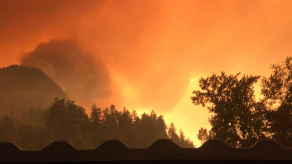 Fire blazes across the Columbia River Gorge. Smoke from the fires is a hazard to health of people living in the surrounding area, causing sports and other outdoor activities to be postponed. 