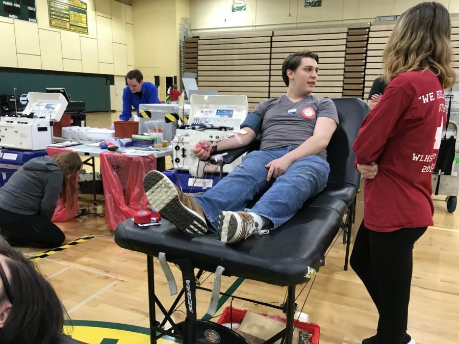Nick Olson donates blood during a Red Cross drive in 2018.