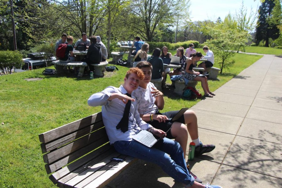Students sit in the sun as the class works outside on their essays in Ms. Spadonis English 12 class. Please tell whoevers in charge to put me in the yearbook. Said Peterson (Left to Right: Mitchell Peterson and Luke Hamper)