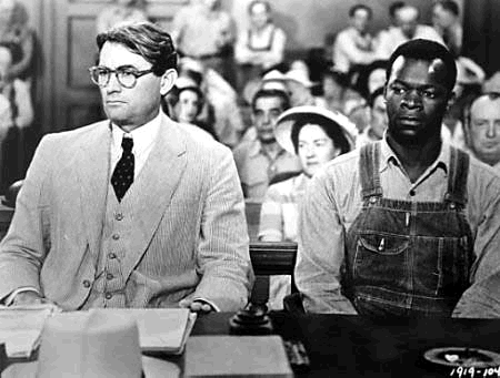 The trial of Tom Robinson from the 1962 classic film adaptation of To Kill a Mockingbird (Left to right: Gregory Peck as Atticus Finch and Brock Peters as Tom Robinson) Courtesy of Universal Pictures