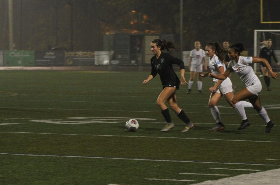 Breaking away from her competition, Caramel Corrigan moves the ball up the field.
