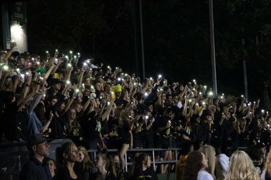Students show support with both cheers and their phones. 