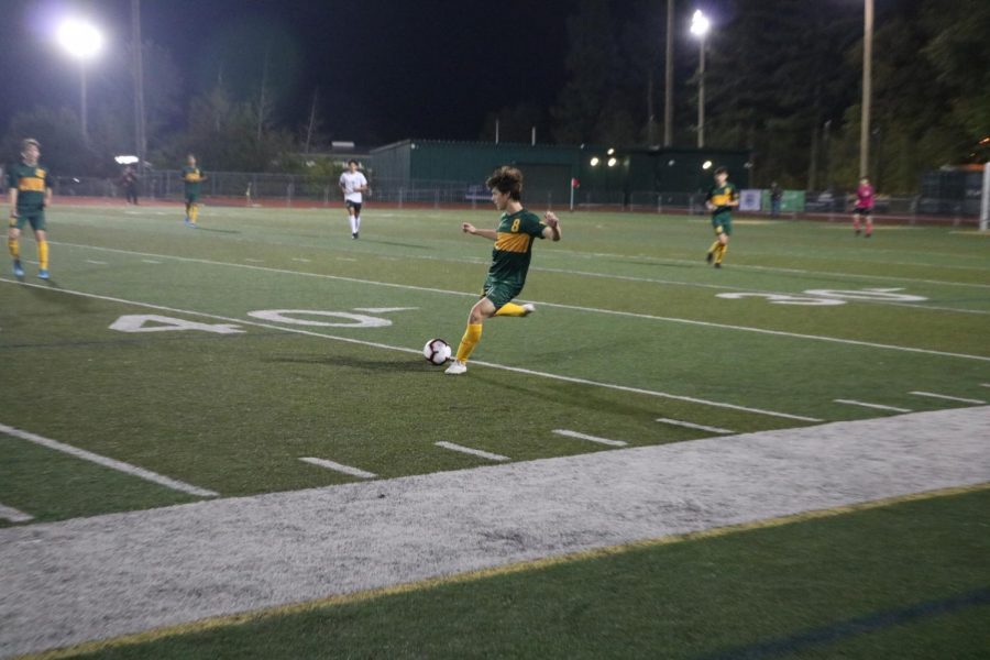 Pushing forward with a wide-open field, Alec Sloan, junior, leads the charge on Tigard’s goal, hoping to change the tide of the game. 