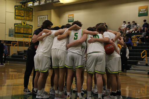 Huddle up! West Linn hosts Lake Oswego to open 6A Three Rivers League competition on Jan. 12. The Lions huddle up and prepare for what will be a very tight game. Down by one with 20 seconds remaining, West Linn pulled through, winning by three. The Lions were led by Jackson Shelstad, junior, and Zeke Viuhkola, senior, who both combined for 59 of the Lion’s 80 total points. “I thought we showed a lot of poise in the second half,” Viuhkola said.  “When things were tough, we stayed out to finish the game.”
