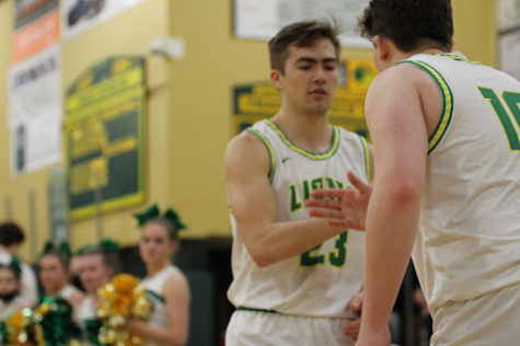Men’s playoffs underway! Zeke Viuhkola, senior, performs a handshake with Jake Holmes, junior. The fifth-seeded West Linn Lions hosted the 28th-seeded Ida B. Wells Guardians on Mar. 1 in the first round of the OSAA 6A playoffs. The Lions defeated the Guardians by scoring 72 points in the last three quarters after only scoring 12 points in the first quarter, “We just keep playing,” Viuhkola said. “We knew we were gonna hit shots later on.” The final score was 90-70 in favor of the Lions.
