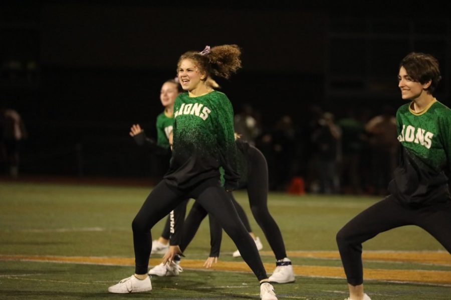 Grace Boyer (left), sophomore, and Brooke Thomsen (right), sophomore, take center stage with the rest of their dance team on September 8th’s football game. 