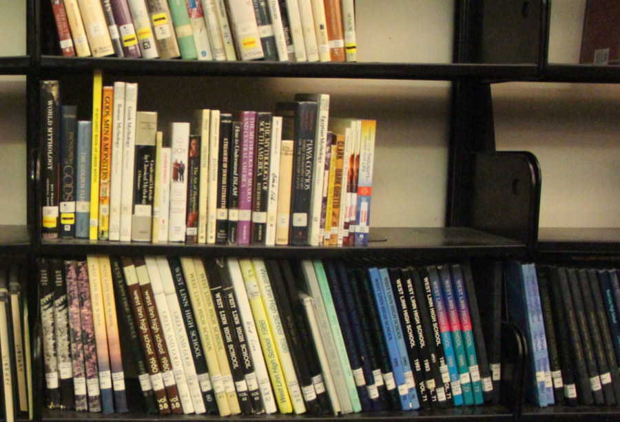 Bookshelf at the library displaying past yearbooks and other nonfiction.
