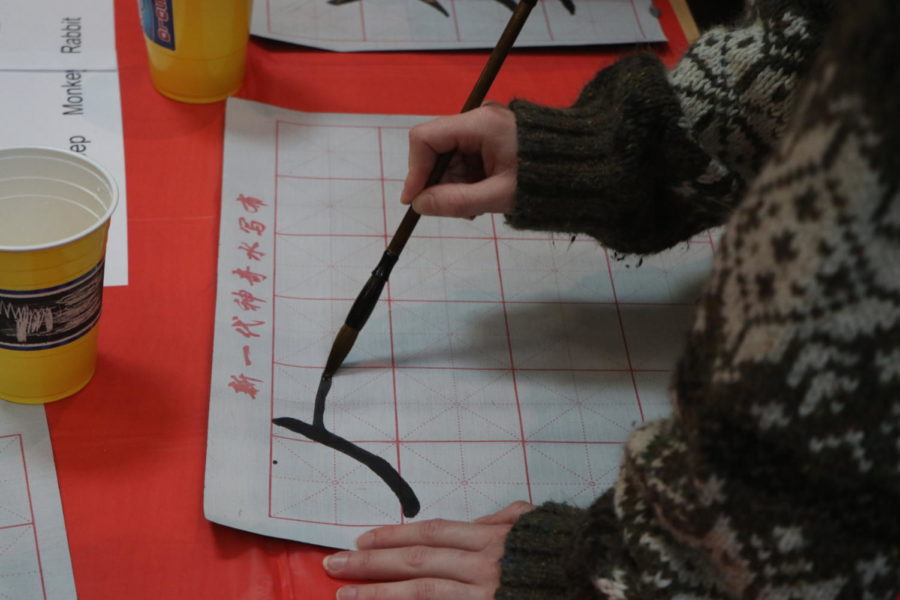 Students practice smooth lines and easy flow at the calligraphy table.