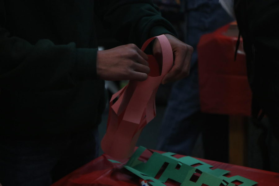 A student folding and cutting to create the perfect lantern. As the event went on, there were students partaking in the activities they had set out, the finished product was a lantern with a yearly aspiration written on it.