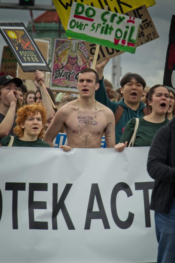 A student wrote the words, seen along the front line of this strike, f*ck the pipeline across his chest.