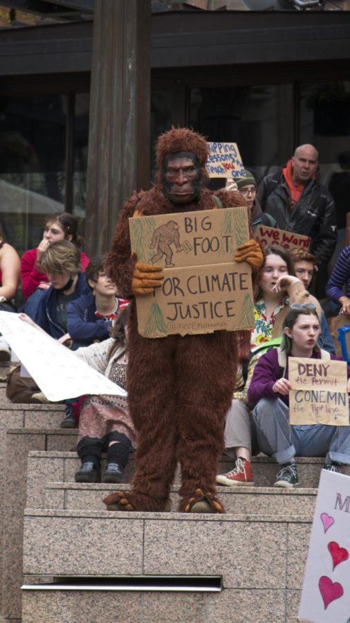 Commonly walking among the group where most visible, a student dressed in a Big Foot costume holding a sign that reads Big Foot for climate justice entertained the group while also stating their views.