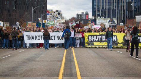 The density of the strike took up both lanes and the sidewalks of the Burnside Bridge as the group continued toward Pioneer Place. There are two banners held at the front of the group. One reads Shut down Zenith oil calling out the company Zenith, a company that carries toxic and flammable materials along unmaintained railroads. The other sign says Tina Kotek, act now, urging Gov. Tina Kotek to keep her promises of staying on top of climate change in the state of Oregon.