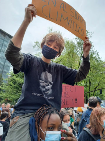 Make it happen. Holding a sign at the Portland Youth Climate Strike that reads “In the climate silence” in Spanish, Samuel Koehler, 11, protests with the crowd. As the group marches through the crowds, Koehler rests on an individuals shoulders to show off their sign. “We are all standing in front of the convention center getting ready to march,” Lucy Lotspeich said. 