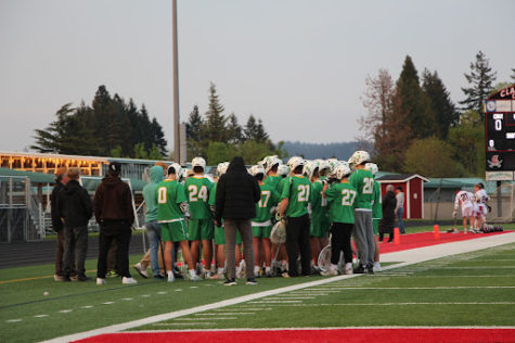 Talking strategy. The team huddles up pregame. Varsity head coach Mark Flood is  considered to be the “father of high school lacrosse in Oregon”, according to Oregon High School Lacrosse Association (OHSLA) commissioner Jim Hammon.