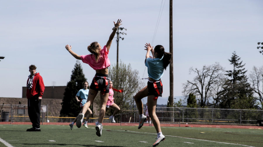 Catch n’ throw. While Gilroy  throws a pass, Angie Nelson, senior, tries to intercept it. The girls worked hard and had sportsmanship through all the games, including the spectators. 