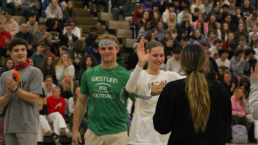 Ryan Vandenbrink and Janina Kraetschmer, seniors, high-five the other Amazing Race teams after their win in the finale.