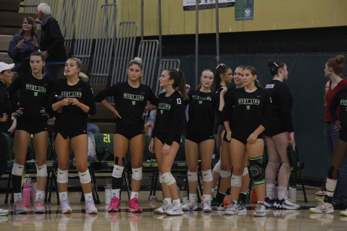 The volleyball team waits on the sidelines during a game on Oct. 16.