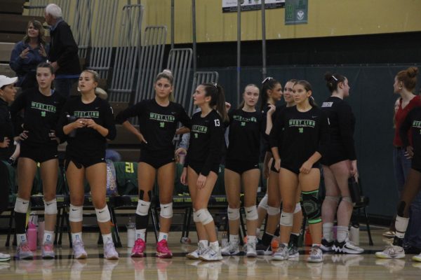 The volleyball team waits on the sidelines during a game on Oct. 16.