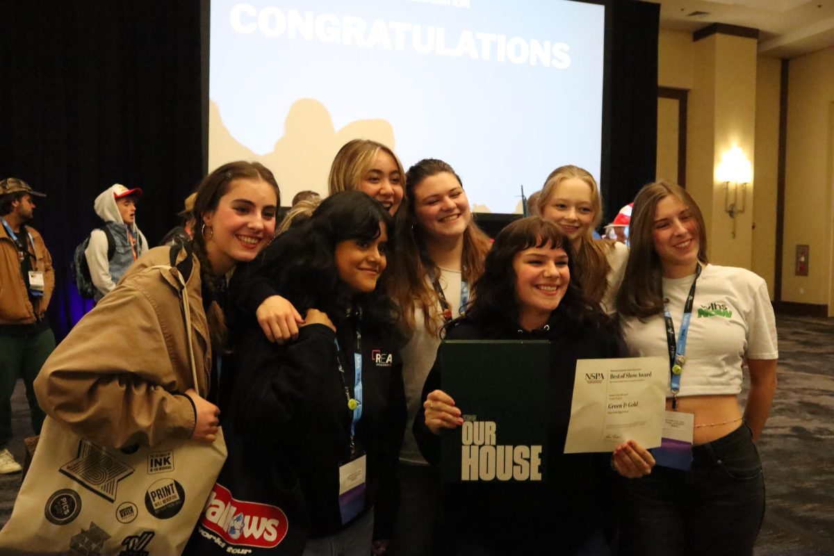 All smiles. The group poses for a photo with last year’s book, “This is Our House,” along with their award for third Best in Show. Meikle, who was an Editor-in-Chief for the yearbook last year as well, holds both and stands at the center of the group. “That was an amazing feeling, going and grabbing the third place award,” Meikle said. “All of it paid off. I cried so much over that book, being able to receive [the award] was one of the highlights of my high school career, it was like the coolest thing ever.”