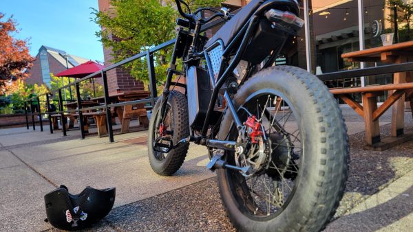 An e-bike resting against a guard rail outside of the Killer Burger near Salamo Road, just down the street from Rosemont Ridge Middle School.  