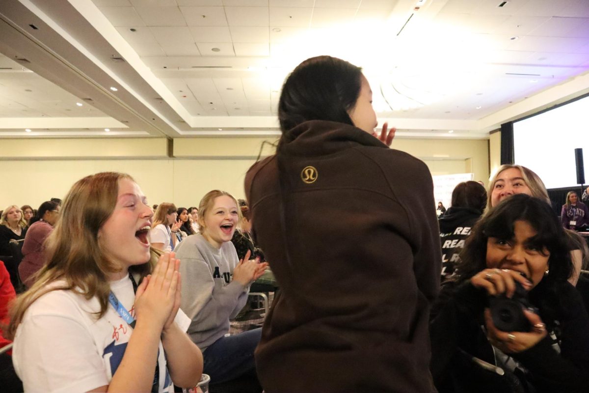 At the awards ceremony on Nov. 10, students celebrate and take photos as their peers stand up to receive their awards from the on-site writing competitions they competed in on Nov. 8.