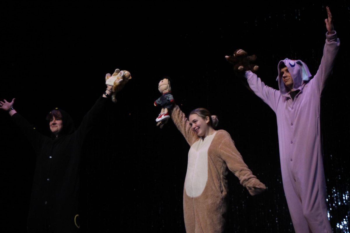 Checkmate. In their onesies, the members of the Chess Club pose with puppets and their hands in the air at the end of their performance. Brooke Loun, sophomore, choreographed the Chess Club’s performance of the song “Mah Na Mah Na” from “The Muppets.” “It was really exciting for me to take this on,” Loun said. “It was a little stressful because I had to choreograph everything, but it was fun.”