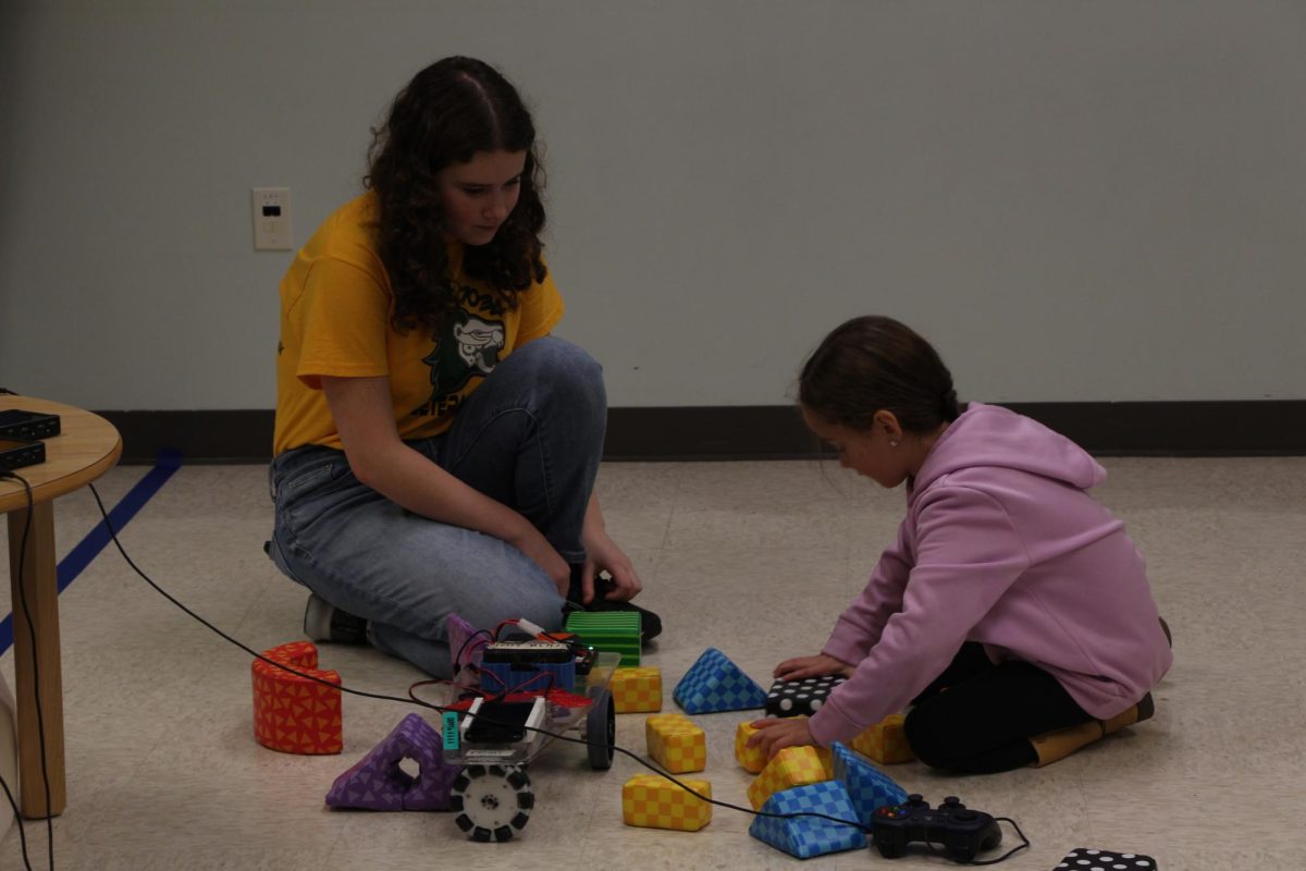 Ravenna Talaga, sophomore, looks out for any help needed from the young girl she is partnered with. Tagala had previously attended this event as an elementary school student and hopes to pass down her passion for STEM to the next generation. “We really want to help teach younger kids about STEM and make them interested in it, and have it be less intimidating,” Tagala said.