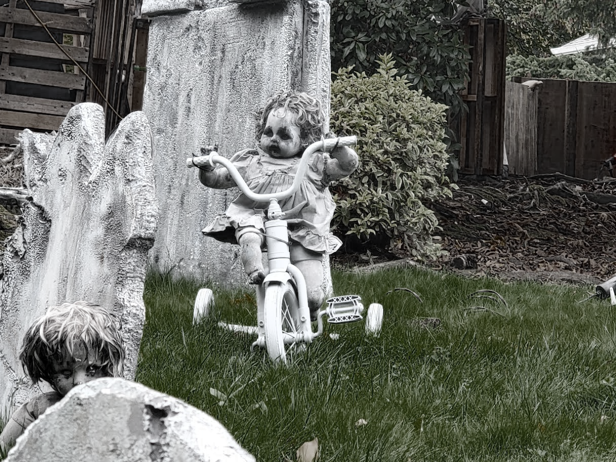 Running amuck: A toy doll rides a tricycle, in the center of the Carriage Way Cemetery. The toy doll was a free listing on Craigslist, among other dolls. “It was a little creepy, just a box of doll parts, but I saw the potential and took it home,” Knowles said. 