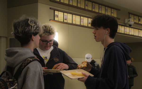 Dean Pervizi, Joseph Peterson, and Thomas Carroll take advantage of the Domino's pizza offered at the cafeteria.