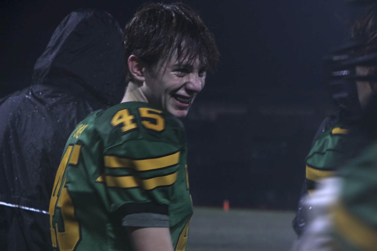 Sideline smiles. Marzley laughs with teammate Baltz. After being in this program with each other for  years, the players will go on to their next season as high schoolers. This game against Tigard, which ended with a victory for West Linn and a final score of 37-8, was their last game of the season before the team parted ways for high school. 