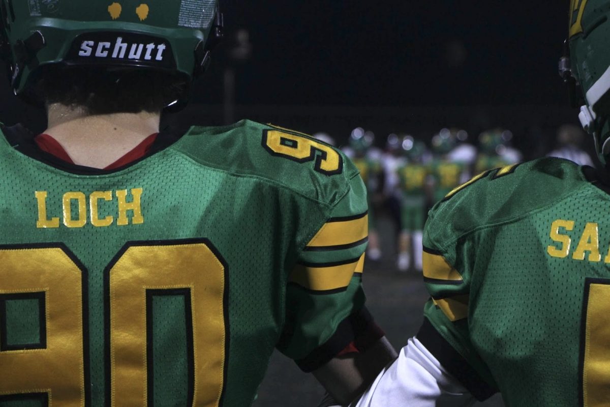 Stronger together. John Loch links arms with Keen Sampson before beginning their last game of the season. “[My favorite part is] hanging out with your friends and coaches for a couple months out of the year and the brotherhood of being with your friends five times a week,” Baltz said.