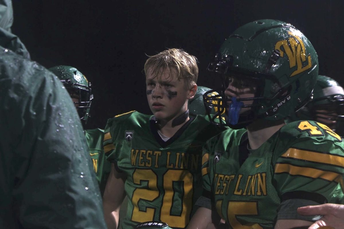 Huddle up. Hudson Hatch, running back and linebacker, and teammate Swayde Marzley, running back and defensive tackle, listen closely to their coach during a huddle. “[One of the best things about playing with the program is] playing football and also getting to play with friends,” Ferguson said.