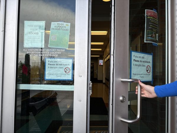 The exterior doors by C porch have signs to warn students and visitors to enter through the front office, as they're locked during class.