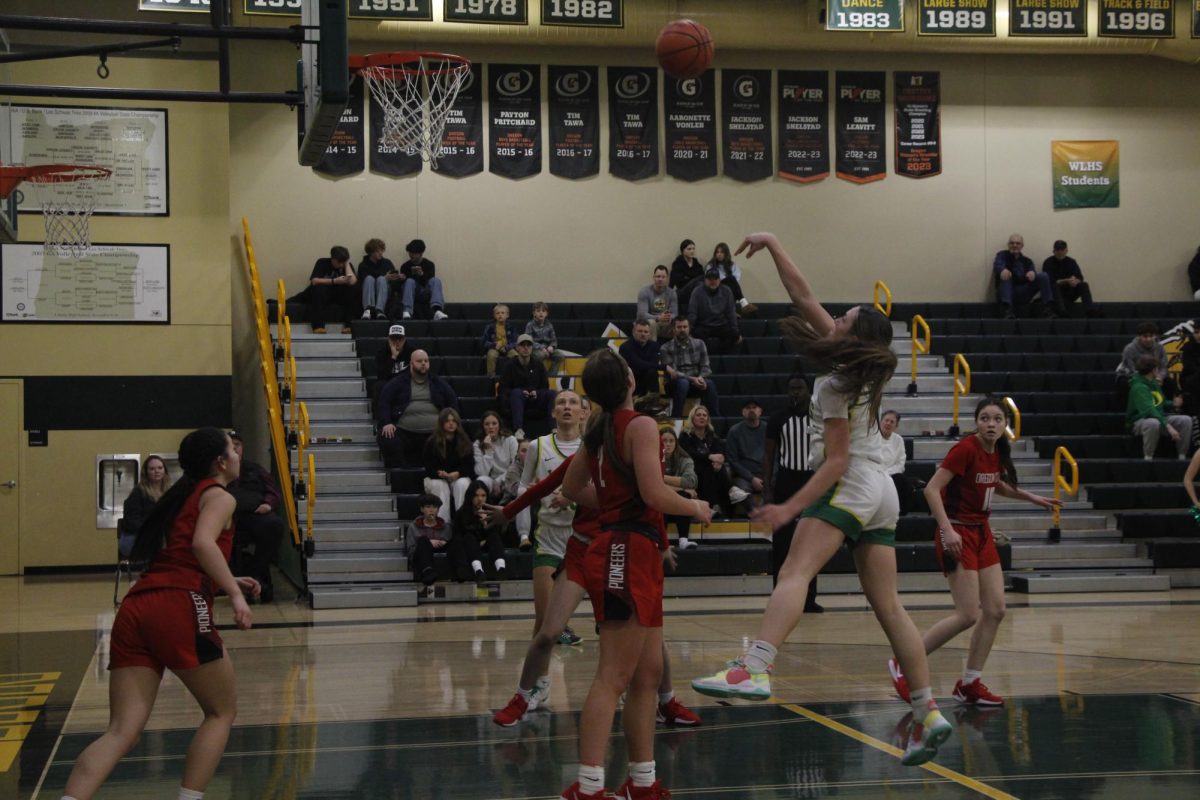 Kaylor Buse, sophomore, makes a shot in the hoop during the third quarter of the team’s game against Oregon City.