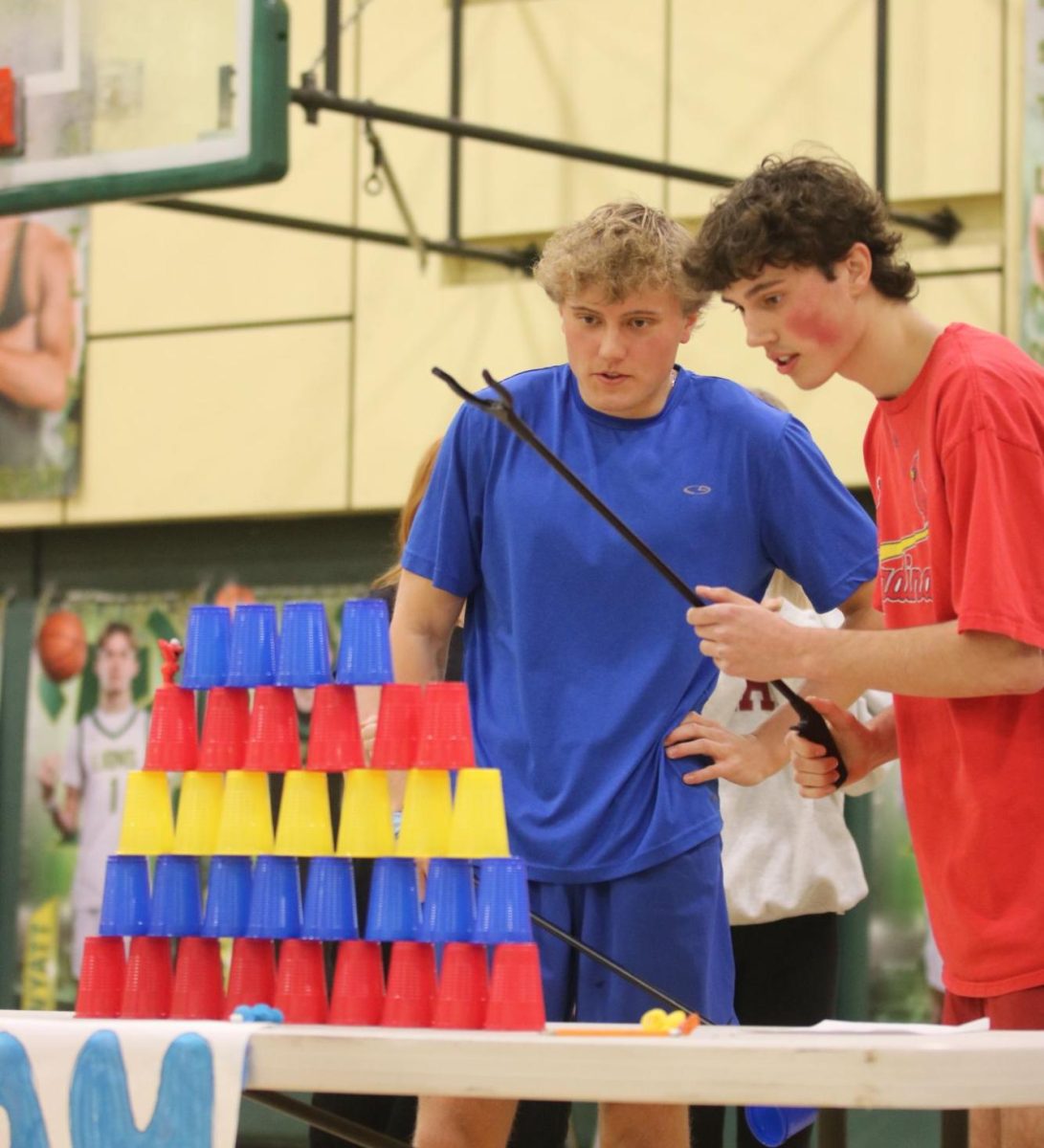 Team sky blue, Evan Spencer and Brennan Jarrell, place cups using a grabber to create a pyramid of nine layers during the last challenge of the Amazing Race on Feb. 27, 2025. 