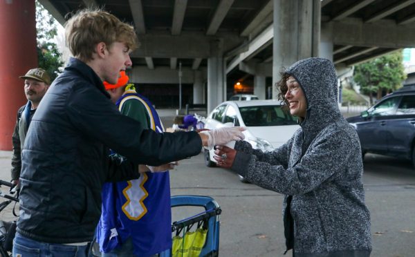 Reaching out. Christopher Lesh, student at Central Catholic High School, serves ice cream during the event on March 2, 2025, at the Portland waterfront. Central Catholic was just one of the schools that sent student volunteers out to cook, prepare, dish, and serve food. Interact club’s co-president Rachel Gerber, junior, plated the food during the event. “I like how direct the contact is,” Gerber said. “You’re there [and] you’re just doing something good. It’s simple, it’s easy, you can feel good about it.”